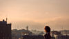 A woman silhouetted against a backdrop of Gothenburg, Sweden – home of Stena Recycling.