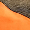 Detailed shot of vibrant orange and black fabric.