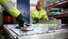 Stena Recycling workers disassembling vehicle batteries.
