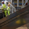 Two female Stena Recycling experts in hi-vis protective gear work in a Stena Recycling facility 